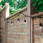 Luxury backyard oasis featuring a custom modern privacy fence and coordinated landscaping by UBL Group.