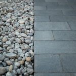 Luxury residential backyard featuring a mix of modern interlock and natural stone borders by UBL Group.