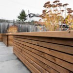 Luxury backyard landscape featuring tiered armour stone walls and coordinated stone steps by UBL Group.